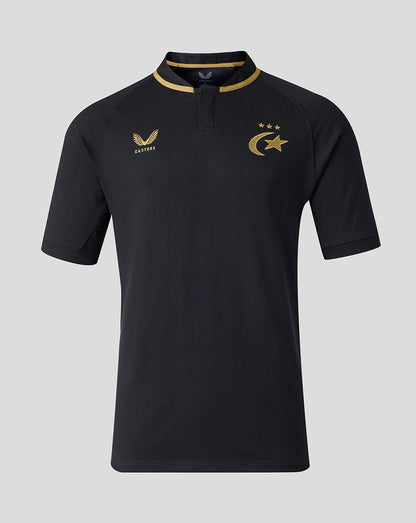 A black short-sleeve polo shirt with gold trim on the collar and gold printed logos on the chest, displayed against a solid gray background.