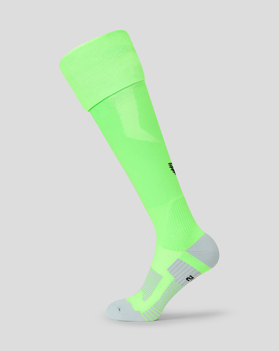 A single knee-high athletic sock in a bright neon green color, shown on a light gray background. The sock features a ribbed cuff, textured knit panels, and a light gray toe and heel.