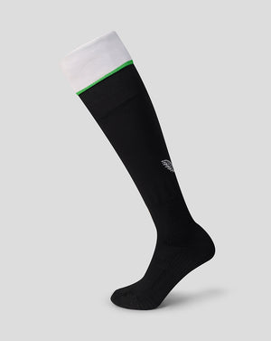 Black knee high sock with white cuff, green stripe, and a small logo on the calf