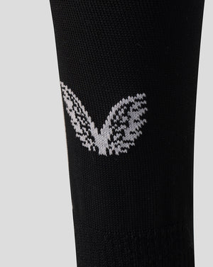 Close up of black Harlequins Home Sock with white knitted wing logo