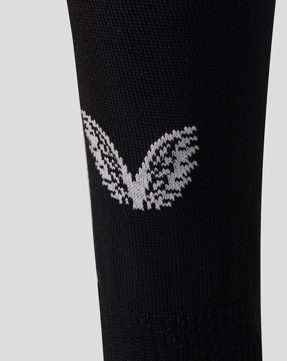 Close up of black Harlequins Home Sock with white knitted wing logo