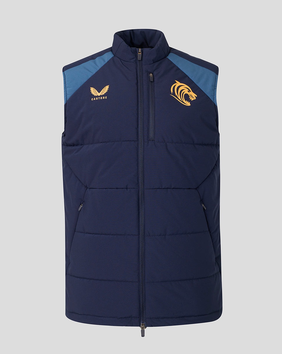 A navy blue sleeveless puffer vest with light blue shoulder panels, featuring a gold eagle logo on the right chest and a gold tiger logo on the left chest, displayed against a solid gray background.