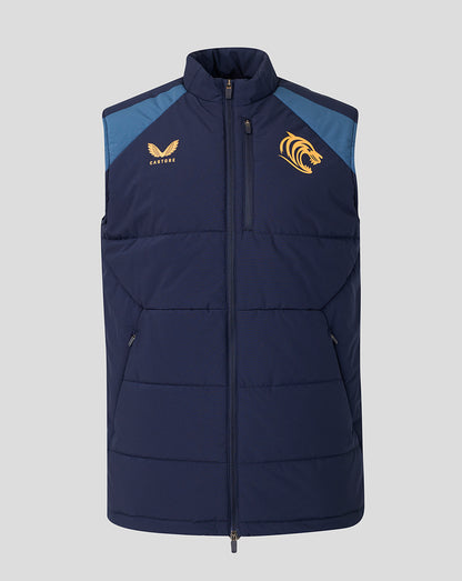 A navy blue sleeveless puffer vest with light blue shoulder panels, featuring a gold eagle logo on the right chest and a gold tiger logo on the left chest, displayed against a solid gray background.