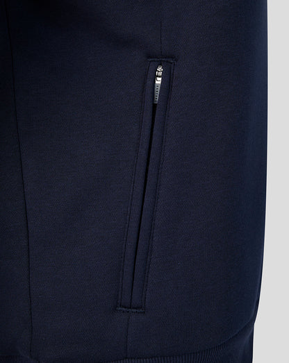 Close-up of navy Travel Hoodie pocket with vertical zip on the side