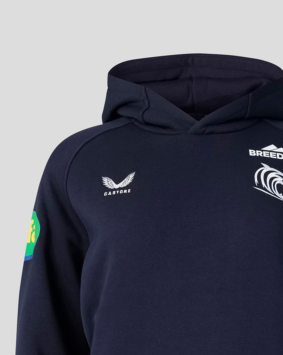 Close up of navy hoodie showing Castore logo BREEDON branding and a green sleeve badge