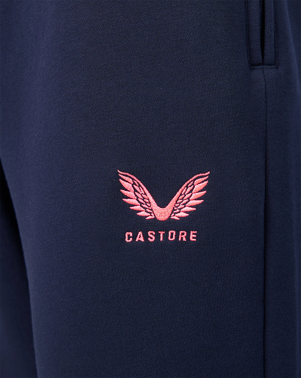 Navy fabric close up with pink Castore logo embroidery on the leg