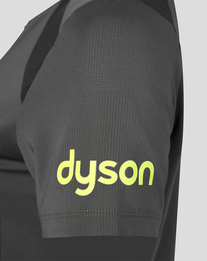 Close-up of a dark gray athletic jersey sleeve featuring a bright yellow-green 'dyson' logo printed on the front, set against a light gray background.