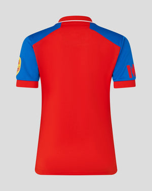Back view of a red and blue color block polo cricket jersey with a red collar and white piping along the neck