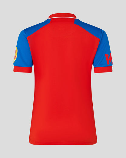 Back view of a red and blue color block polo cricket jersey with a red collar and white piping along the neck