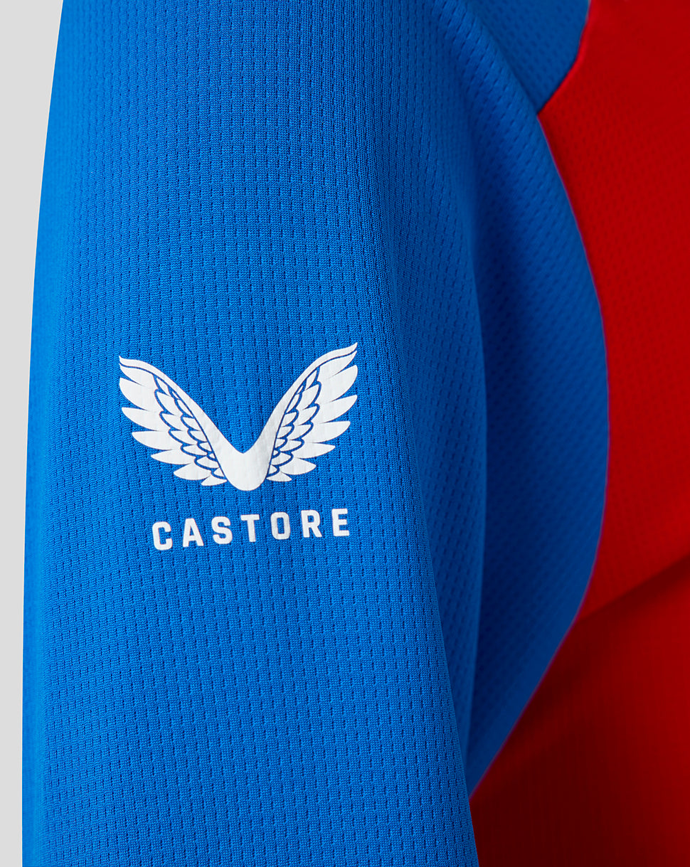 Close-up of blue sleeve with Castore wing logo and white lettering on England women's T20 WWC replica shirt