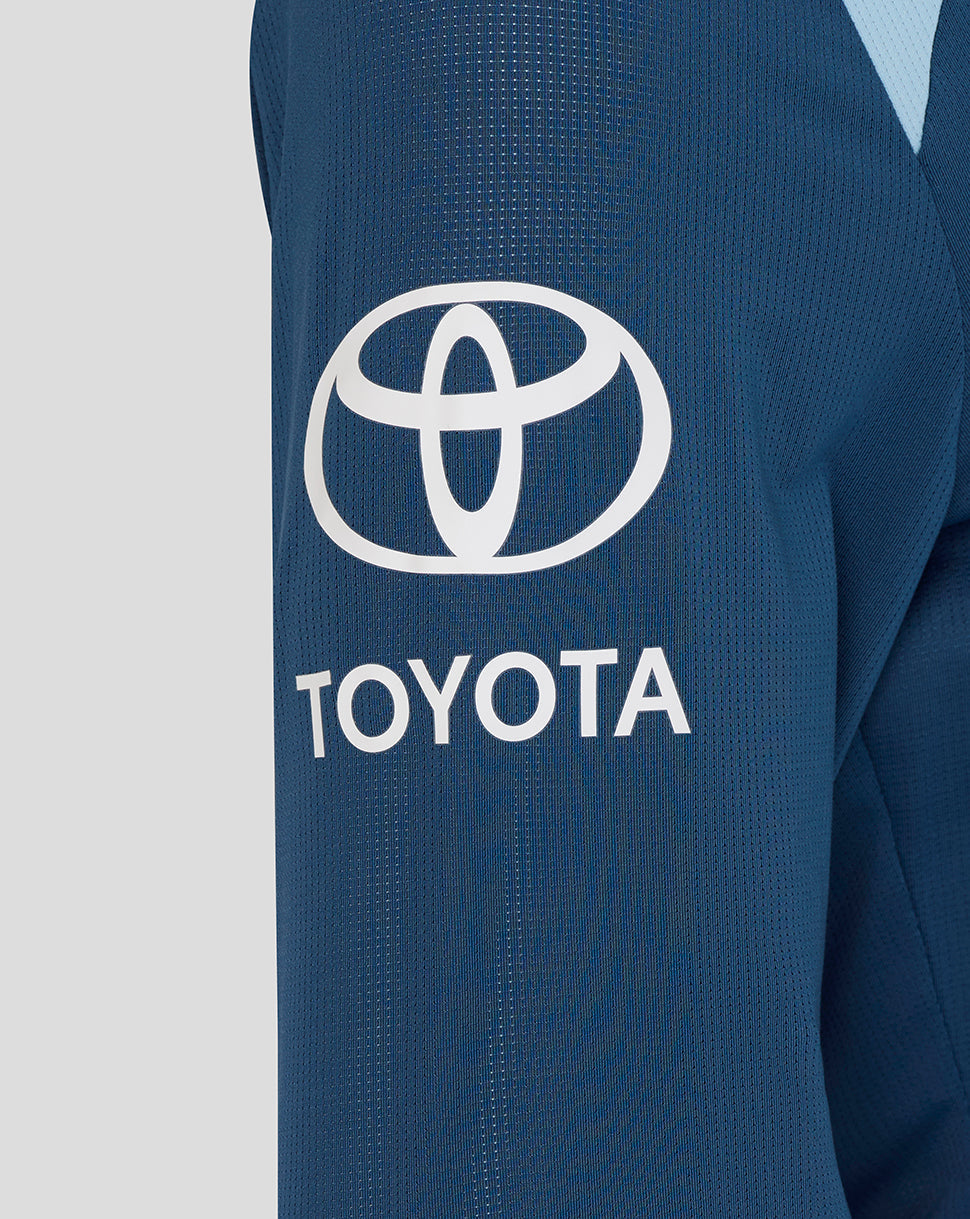 Close-up of a blue jacket with Toyota logo on a light gray background