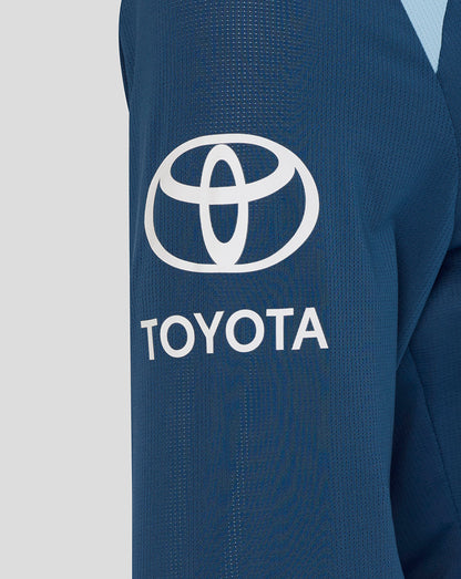 Close-up of a blue jacket with Toyota logo on a light gray background