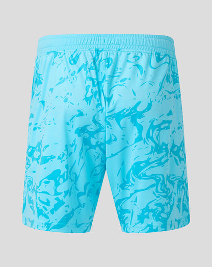 Blue swim shorts with a pattern on a gray background