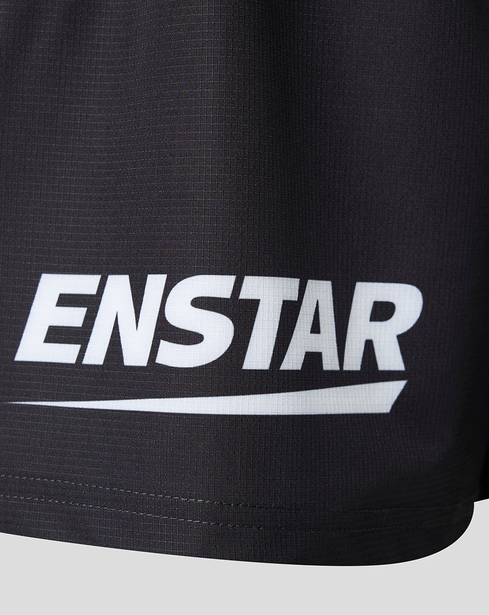 Close-up of black athletic shorts with a large white ENSTAR logo printed across the front, set against a light gray background.