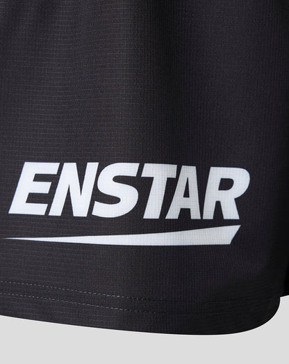 Close-up of black athletic shorts with a large white ENSTAR logo printed across the front, set against a light gray background.