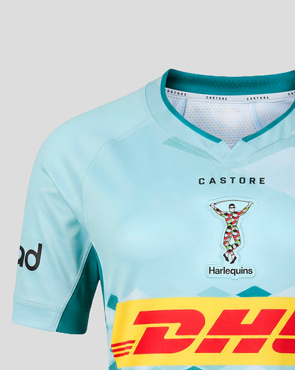 Close-up of a light blue cycling jersey with teal accents, featuring the Castore and Harlequins logos on the chest and a large yellow DHL sponsor stripe across the lower front.