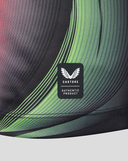 Close-up of athletic shirt showing a black Castore Authentic Product label sewn onto a dark gray and green wavy patterned fabric.
