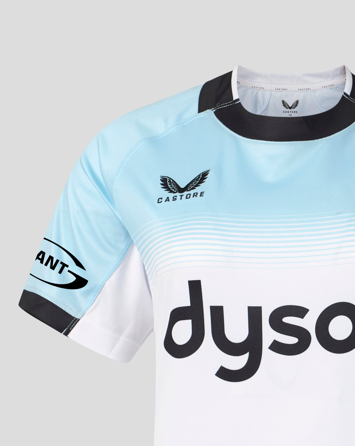 A close-up of a light blue and white Castore soccer jersey with black trim, featuring the 'dyso' sponsor logo on the front and a 'Giant' sleeve logo, set against a neutral gray background.