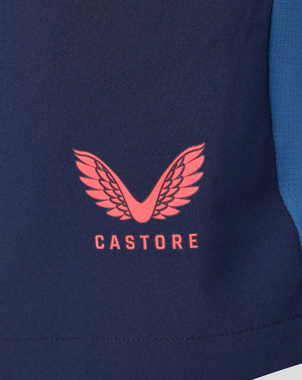 Close-up of a navy blue jacket with a red Castore logo on a white background