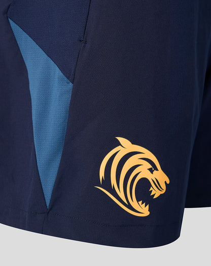 Close up of navy shorts with light blue side panel and gold tiger logo at the hem