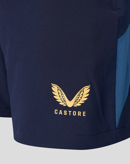 Gold Castore logo with wings on navy fabric near the hem
