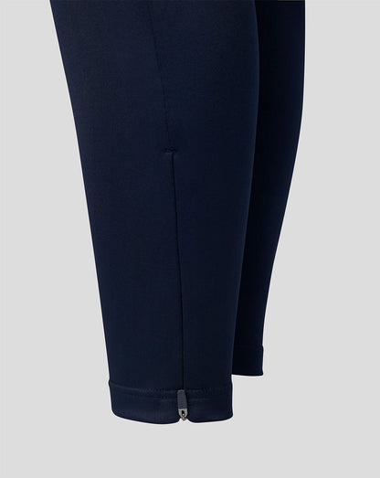 Ankle view of navy training pants showing a small zipper at the cuff