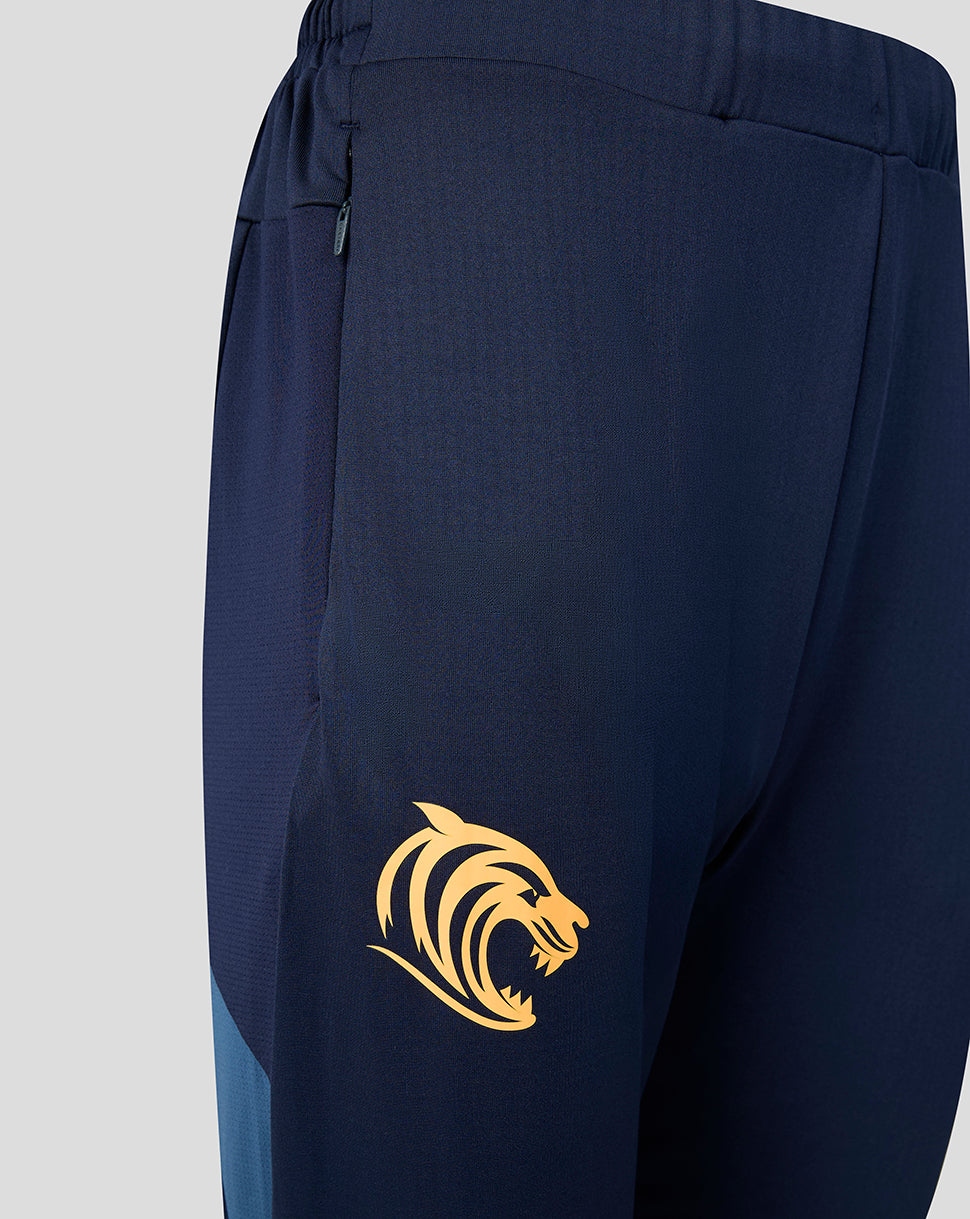 Close up on navy Leicester Tigers training pants showing a gold tiger crest on the leg