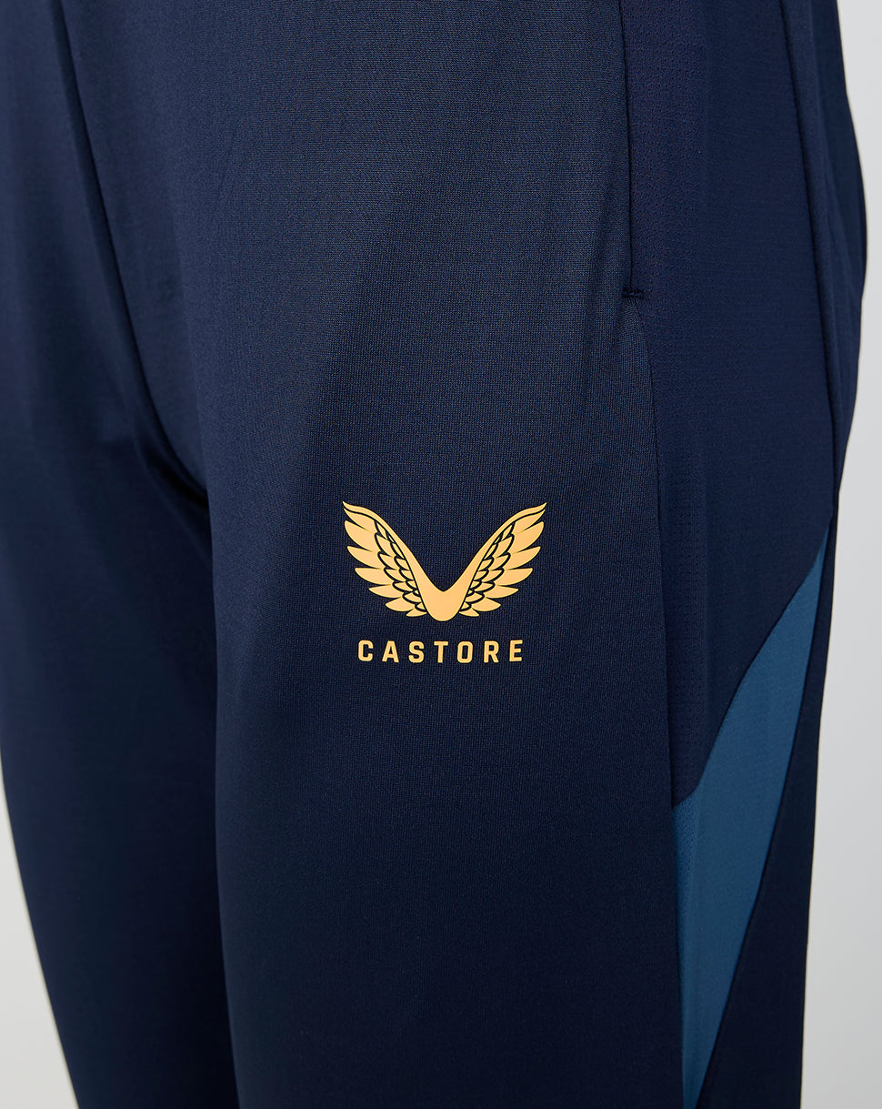 Close up of navy Leicester Tigers training pants leg with gold Castore logo.