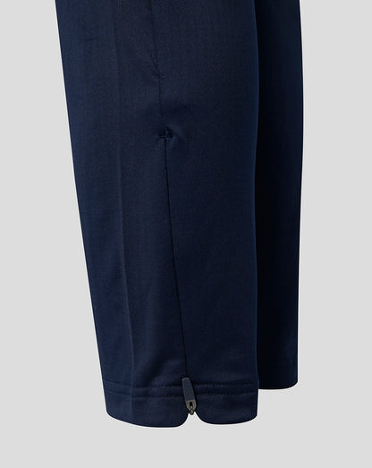 Close up of navy training pants lower leg with zip at ankle.