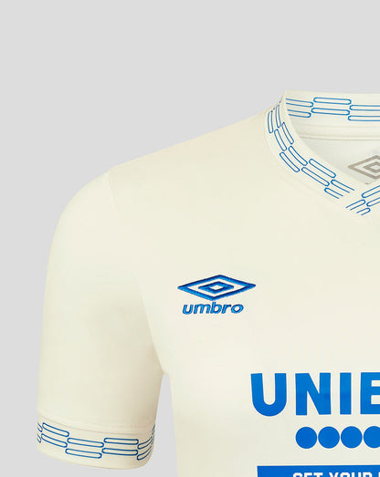 Beige sports jersey with blue accents and Umbro logo on a light gray background