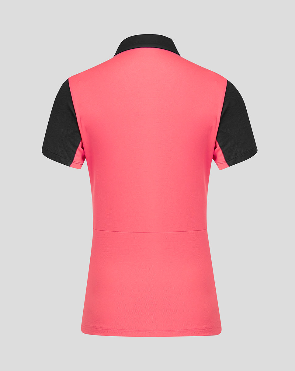 Pink and black short sleeve top on a gray background