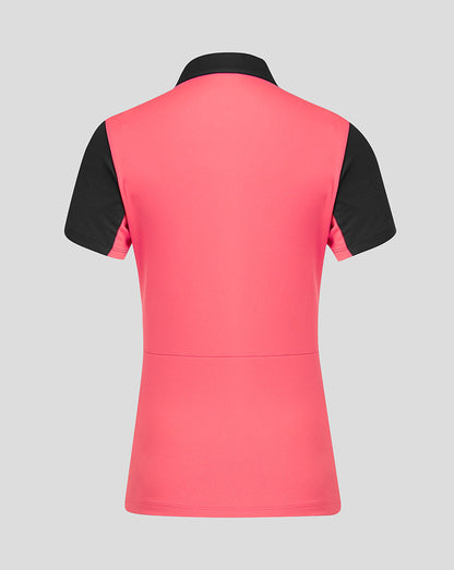 Pink and black short sleeve top on a gray background