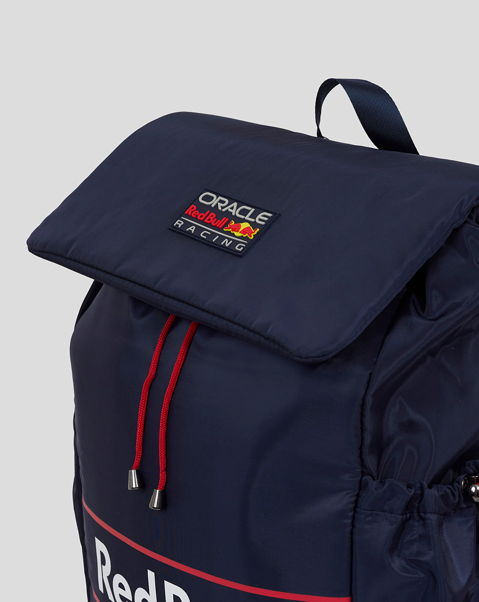Navy backpack with a folded top flap red drawstrings and Oracle Red Bull Racing patch on the front.