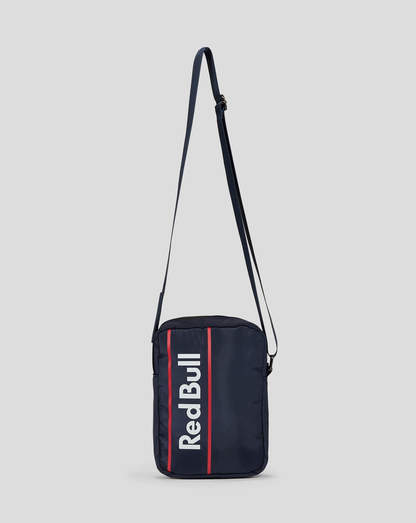 Navy crossbody bag with a bold red vertical stripe and Red Bull branding.