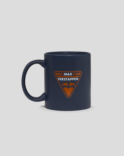 Dark blue mug featuring the orange Max Verstappen Red Bull Racing crest on the front with a handle on the left.
