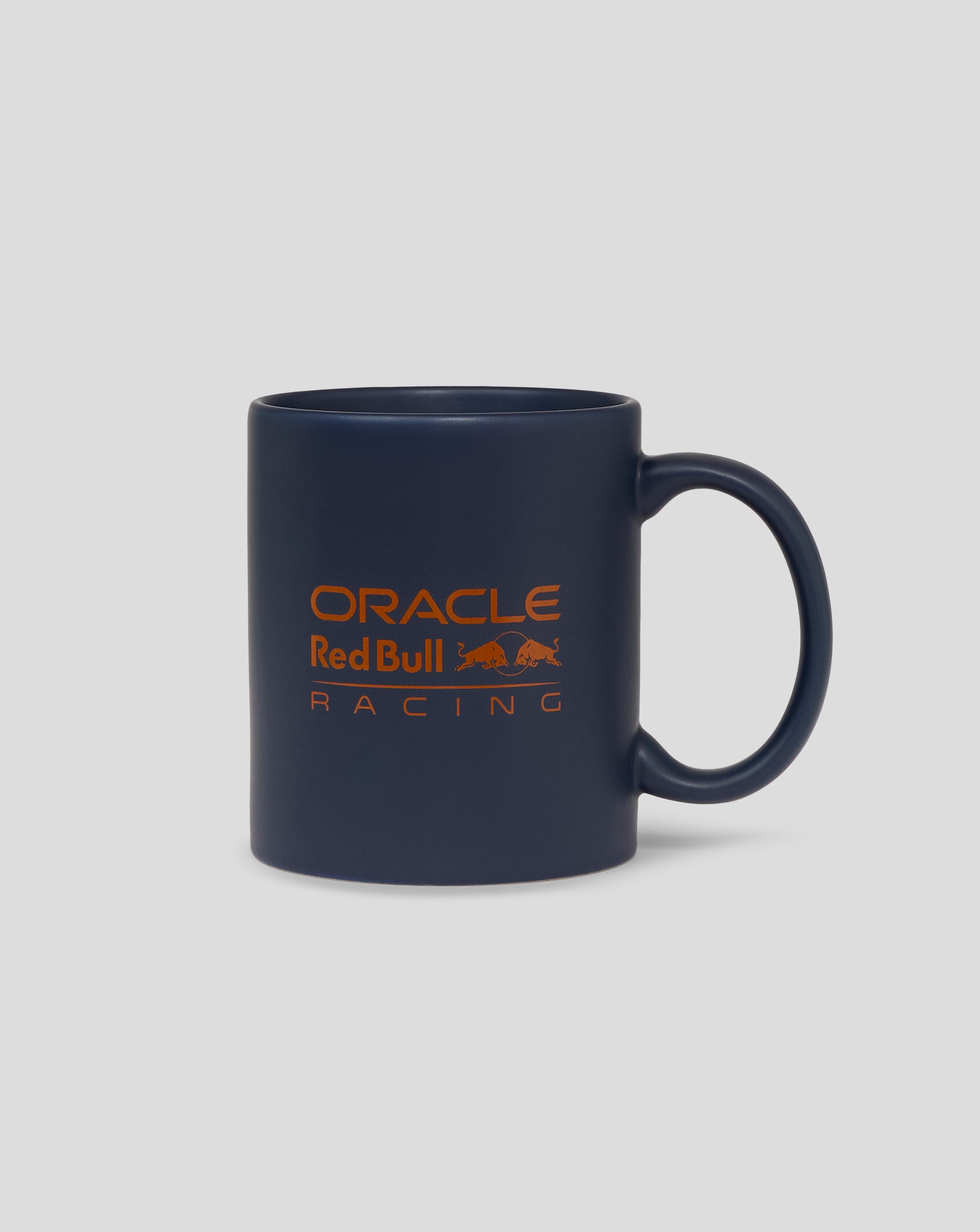 Dark blue mug with orange Oracle Red Bull Racing logo and a left side handle.