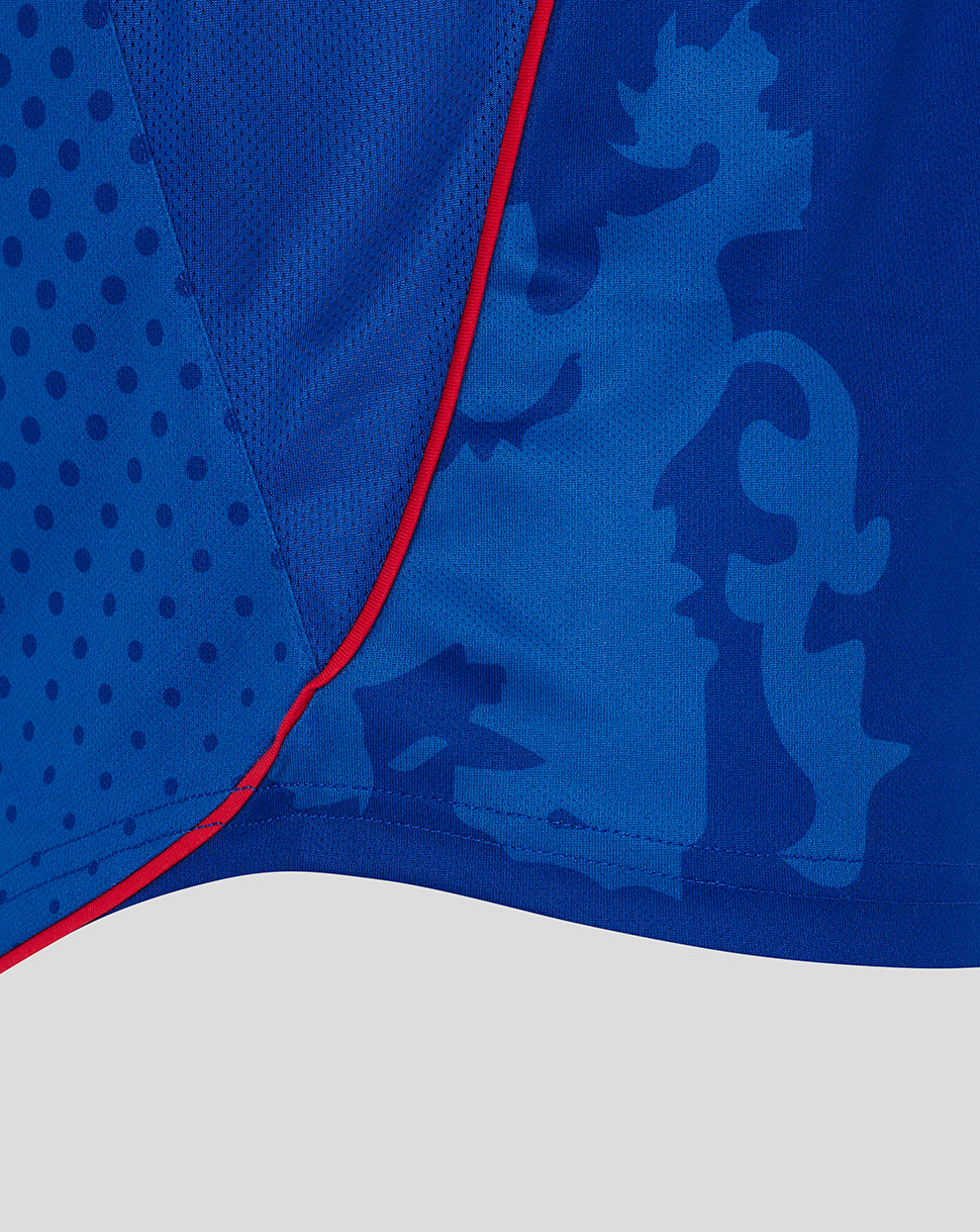 Close-up of blue Rangers retro home shirt showing dotted panel and red piping along the front seam.