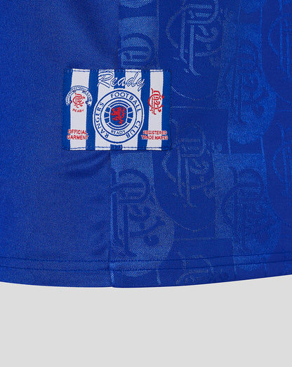 Close-up of Rangers crest patch on blue jersey with a white and blue striped background.