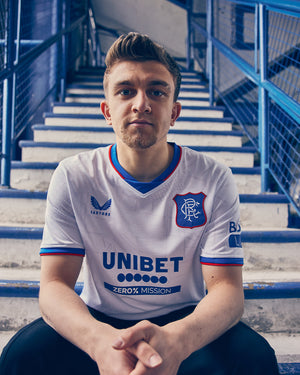 Man wearing Rangers away shirt in white with blue trim and Unibet sponsor