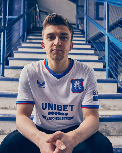 Man wearing Rangers away shirt in white with blue trim and Unibet sponsor