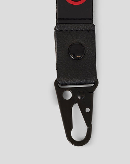 Official Haas Team Lanyard close up in black with red branding and a clip attachment