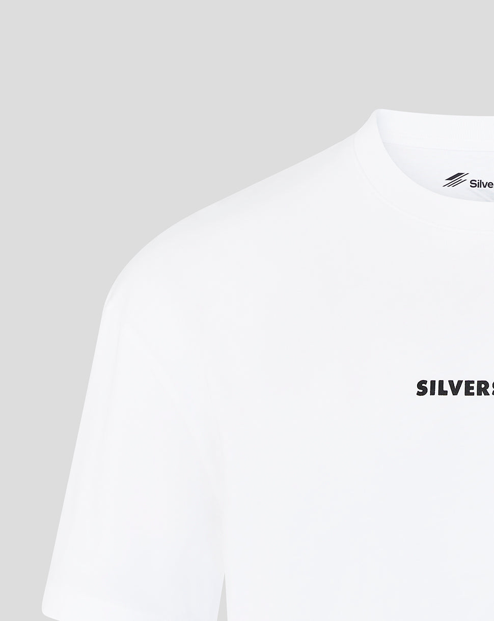 Close-up of a white short-sleeve T-shirt with black 'SILVER' text printed on the chest and a small black 'Silver' logo printed inside the collar, shown against a light gray background.