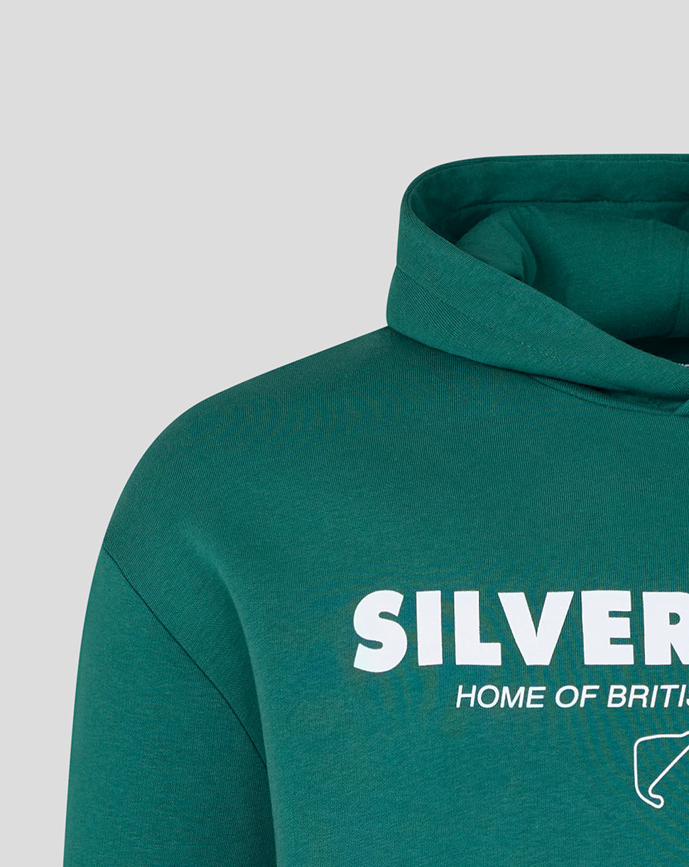 Close-up of a dark teal-green hoodie with a white graphic print reading 'SILVERSTONE' and 'HOME OF BRITAIN' on the chest, shown against a light gray background.