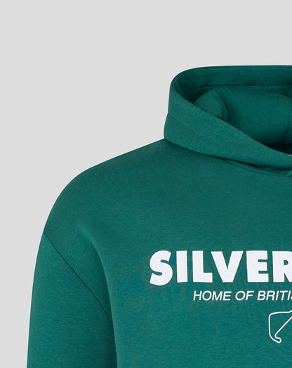 Close-up of a dark teal-green hoodie with a white graphic print reading 'SILVERSTONE' and 'HOME OF BRITAIN' on the chest, shown against a light gray background.