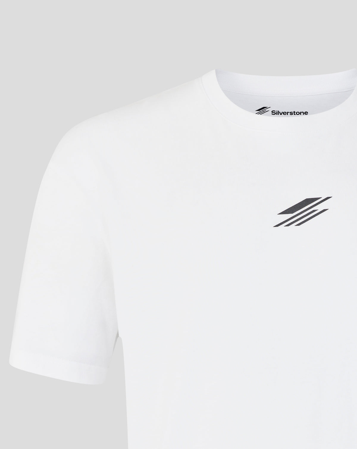 A close-up of a white short-sleeve crewneck t-shirt by Silverstone, featuring a small black logo on the left chest and the brand name printed inside the collar.