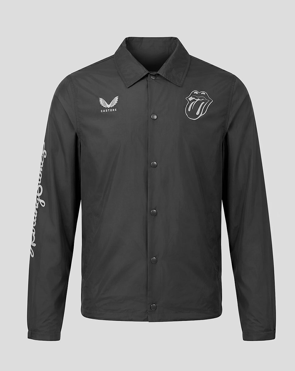 A dark gray button-up coach jacket featuring white embroidered logos: the Rolling Stones tongue and lips logo on the left chest, a Cricket brand logo on the right chest, and 'Rolling Stones' written vertically down the right sleeve, shown against a solid gray background.