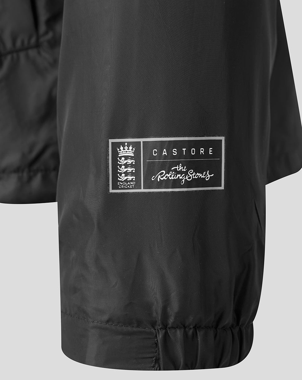 Close-up of a black lightweight jacket sleeve featuring a white Castore x The Rolling Stones patch on the side.