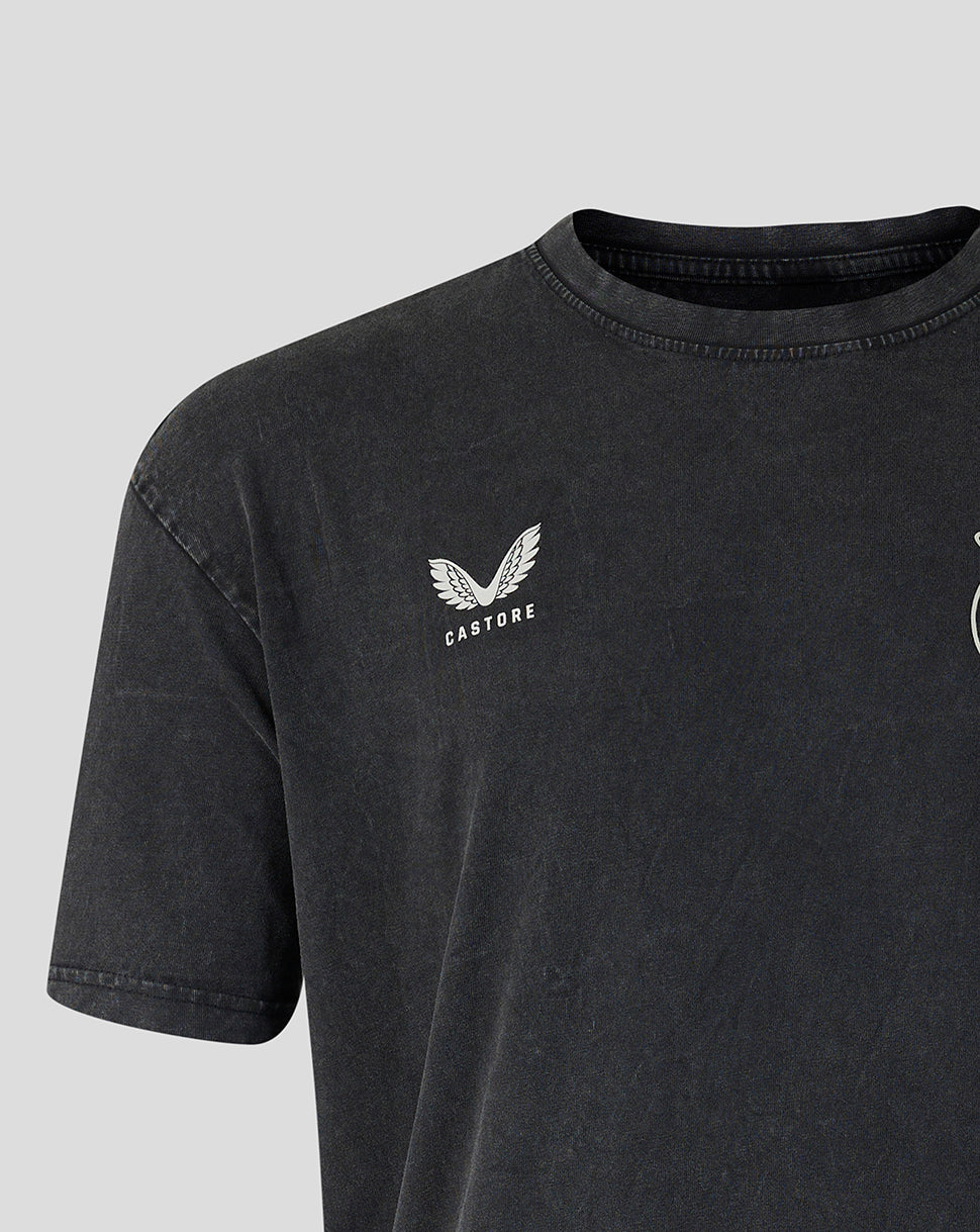 Close-up of a dark washed charcoal gray t-shirt featuring a white embroidered winged logo and the word 'CASTORE' on the left chest, set against a light gray background.