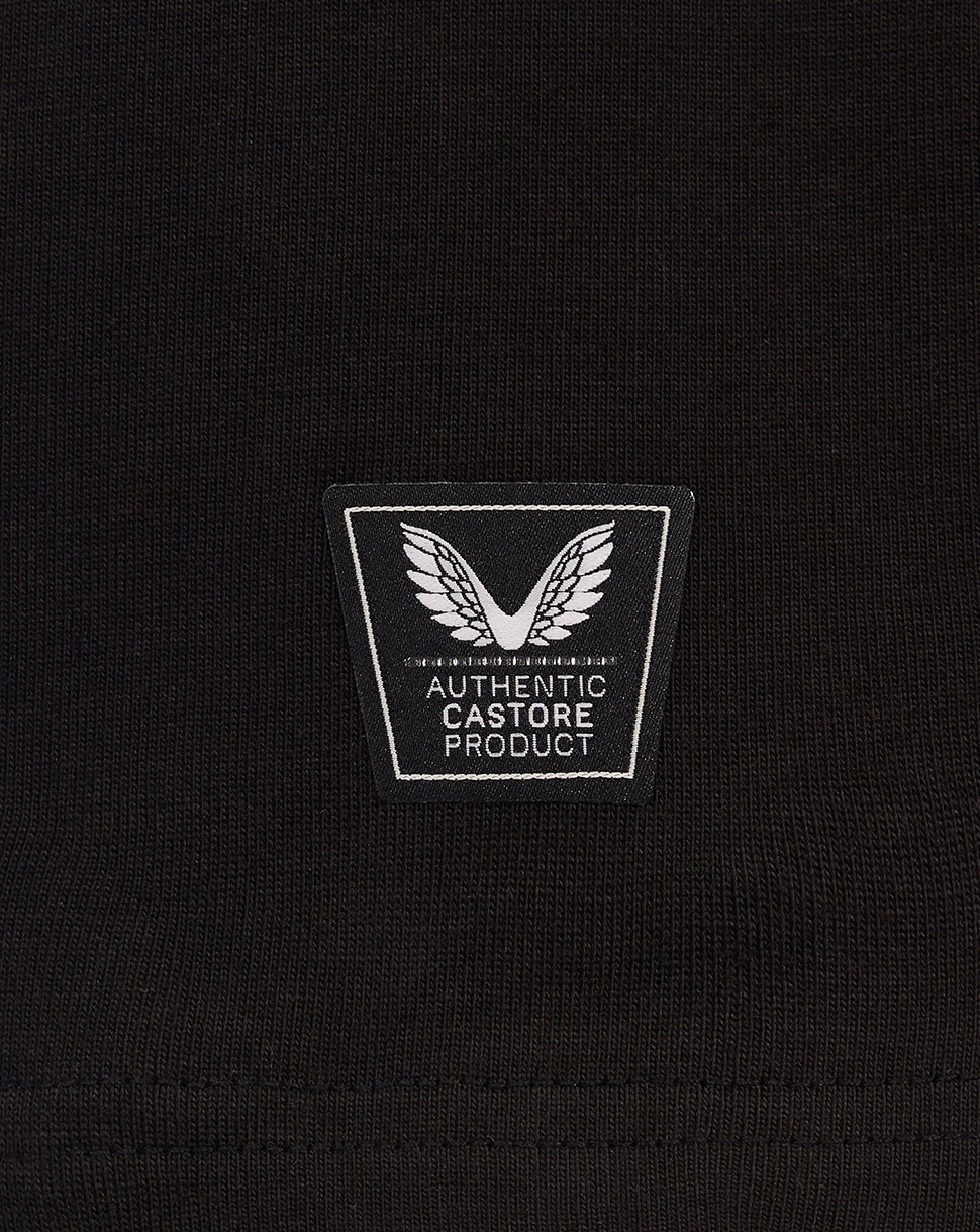 Close-up of a black knit fabric with a square authentic Castore product patch featuring wings.