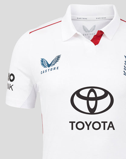 Close up of the chest on a white England cricket jersey showing the Castore emblem on the left and the Toyota sponsor across the front with red collar trim.